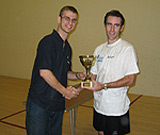 Alex Gough receiving his trophy from Geoff Woodcock, manager of The Racket Shop