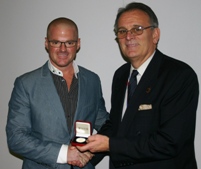 Heston Blumenthal receives his gold medal from Mike Tyrrell