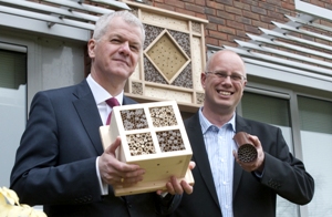 Sir David Bell and Professor Simon Potts in front of the new bee hotel