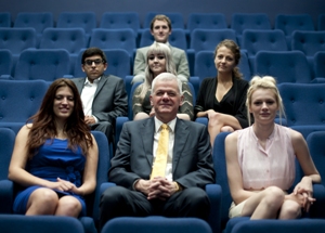 On screen: Vice-Chancellor Sir David Bell with the successful students
