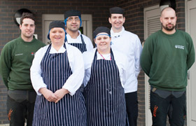 the University's Catering and Grounds staff wearing their ethically procured clothing