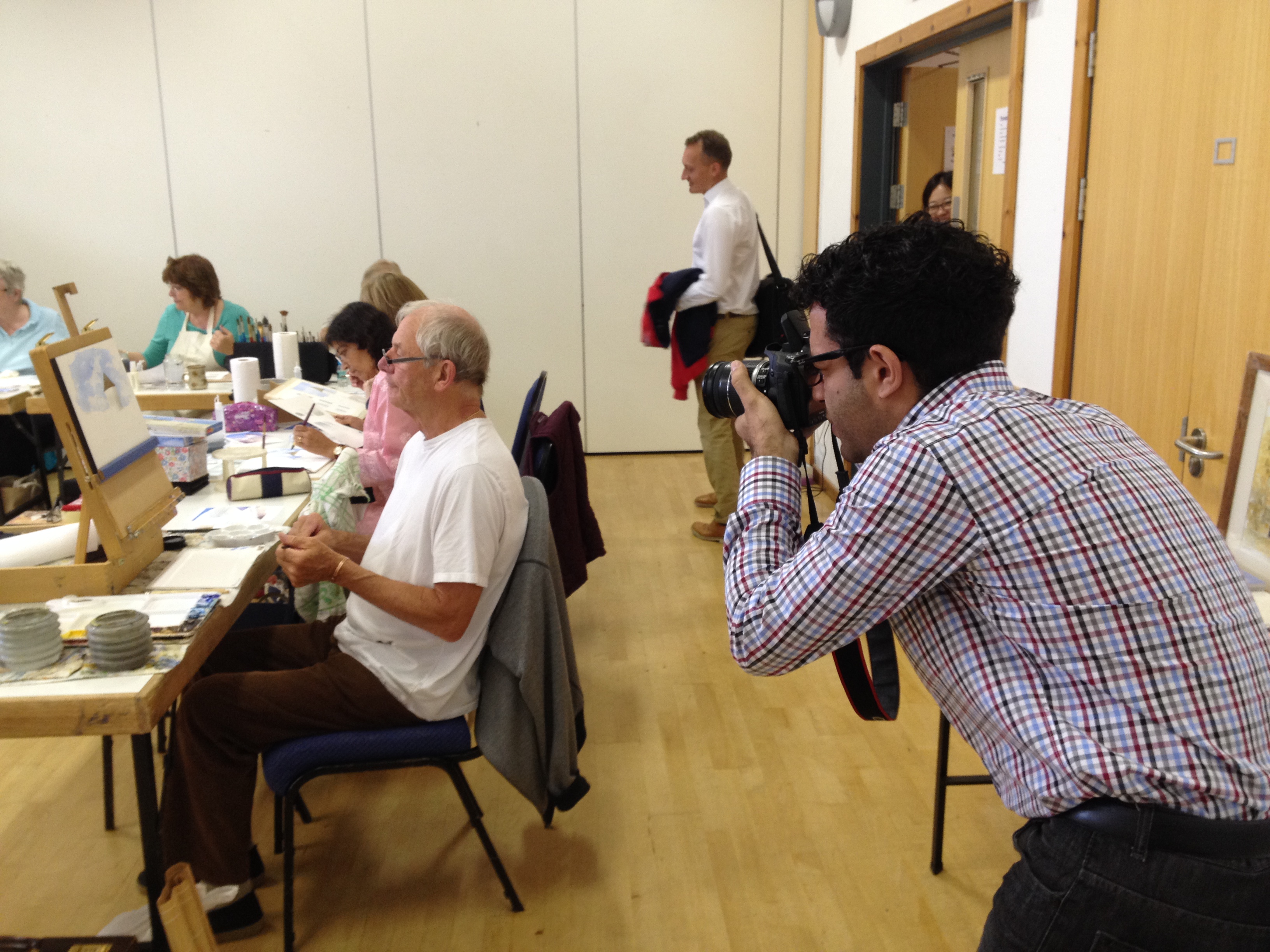 Student photographing a community art class