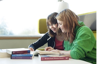 Two students studying books together