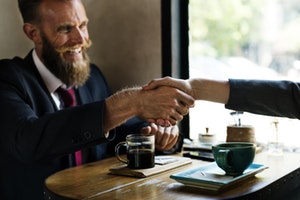 Business handshake - increasingly being replaced by a hug according to US study