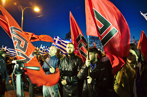 Golden Dawn members hold flags with the meander symbol at a rally outside of party HQ, Athens, March 2015