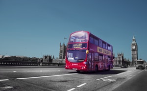 Red London Bus crossing Westminster Bridge