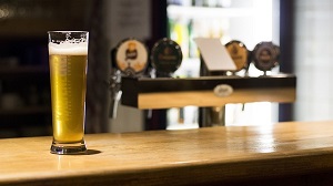 A pint of lager at a pub bar