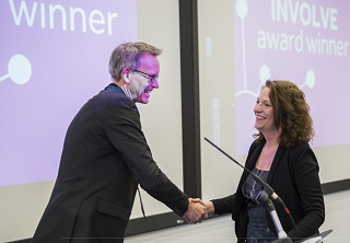 Phil Newton presents Sally Lloyd Evans with her INVOLVE award