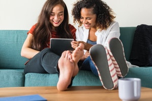 Friends sitting talking on a couch/sofa/settee