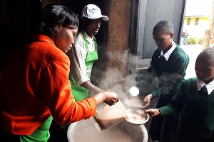 Children being served finger millet porridge in Tanzania. Credit: Christine Wangari/ICRISAT