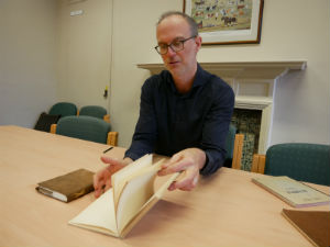 Composer Tim Parkinson studies one of Samuel Beckett's notebooks from the Collection