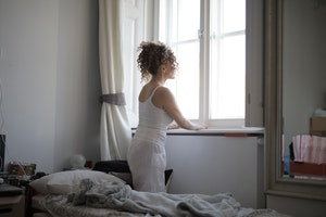 Woman alone looking out of window