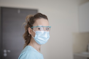 Friendly community pharmacist wearing mask and goggles