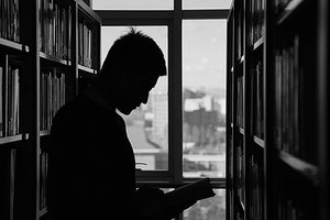 Man in silhouette in a university library