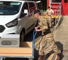 RT-PCR machines being collected by members of the Royal Logistical Corps