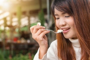 Woman eating yoghurt