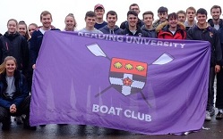Colour photograph of Reading University Boat club members holding club flag at event