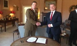 Colour photograph of vice chancellor Robert Van de Noort  shaking hands with RMAS commandant Paul Nanson
