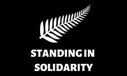 Standing in Solidarity logo white fern and lettering to black background