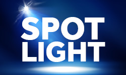 Spotlight logo, graphic of spotlight and white lettering to blue background