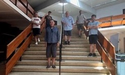 Colour photograph of group of people standing in stairs