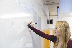 Female colleague using whiteboard