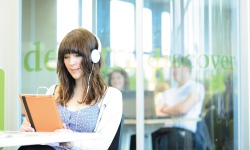 Student wearing headphones on laptop